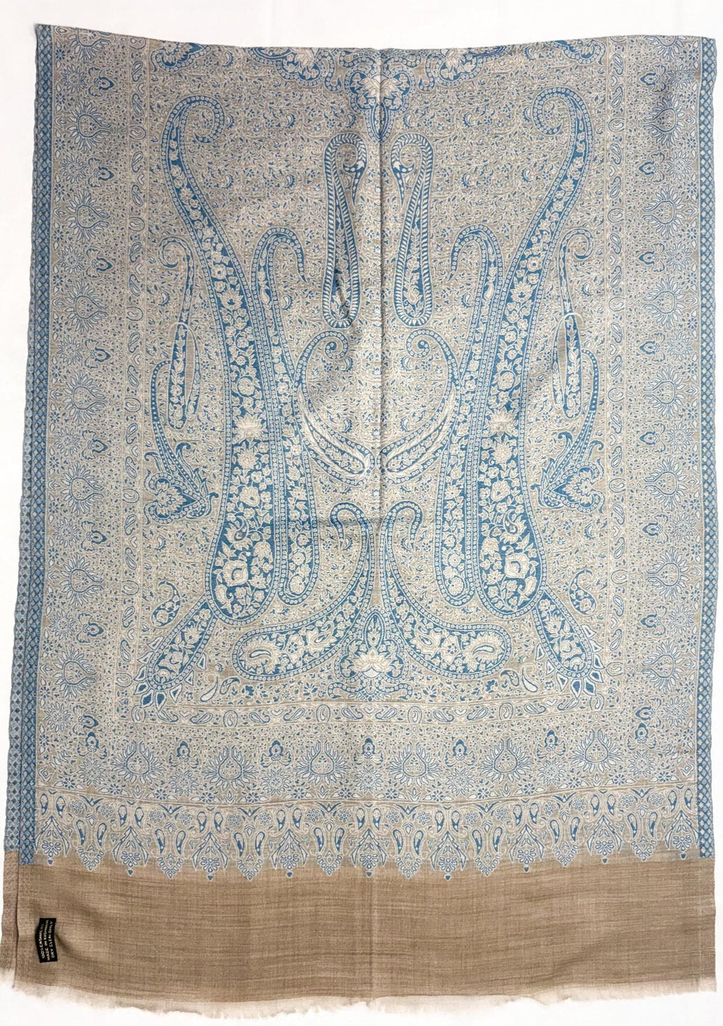 Decorative fabric with intricate blue paisley pattern on a white background
