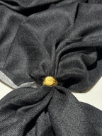 Gold ring on a knotted black fabric