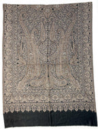 Decorative scarf with intricate paisley pattern on a plain background