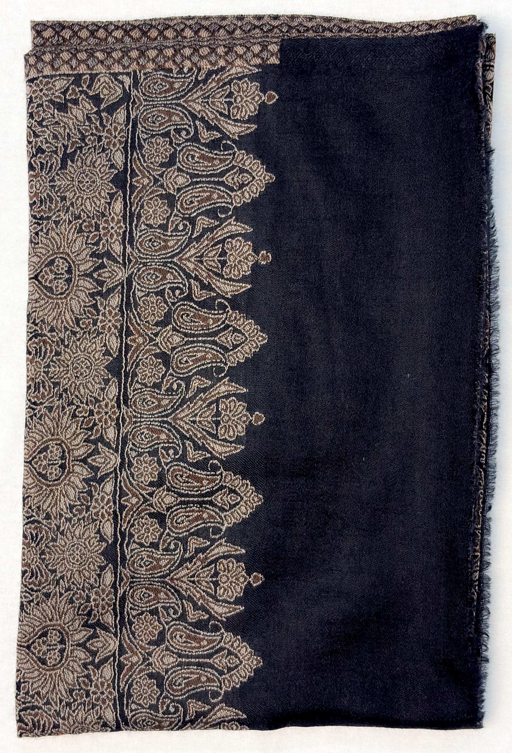Black scarf with intricate beige paisley patterns on a white background
