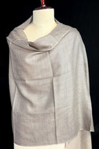 Gray scarf on a mannequin against a black background