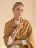 Woman wearing a brown scarf with a neutral background