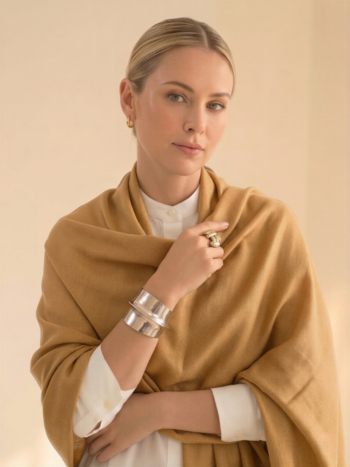 Woman wearing a brown scarf with a neutral background