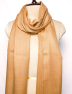 Beige scarf draped over a mannequin on a white background