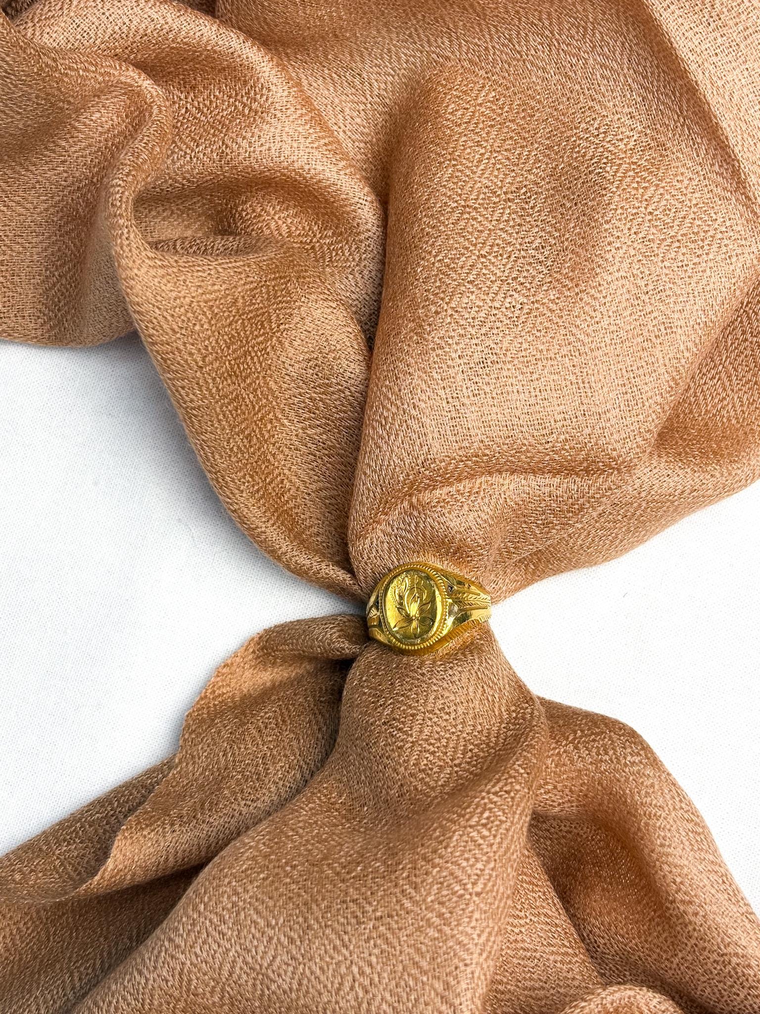 Brown fabric with a gold button on a white background