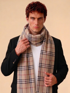 Man wearing a plaid scarf against a beige background