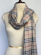 Plaid scarf on a mannequin with a plain background