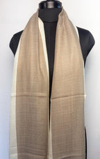 Beige and white scarf on a mannequin against a white background