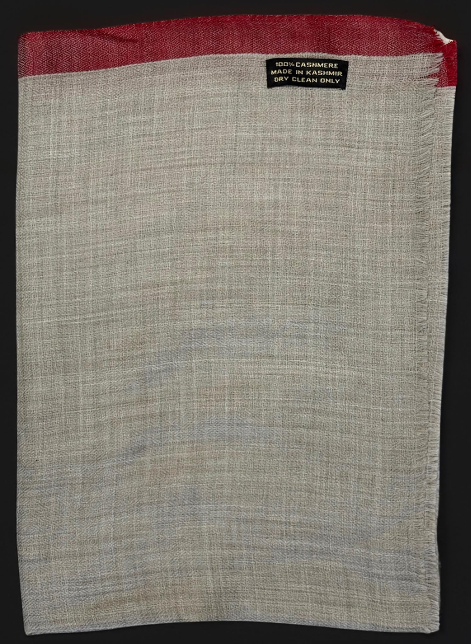 Gray fabric with red border and 'Dry Clean Only' label on a black background