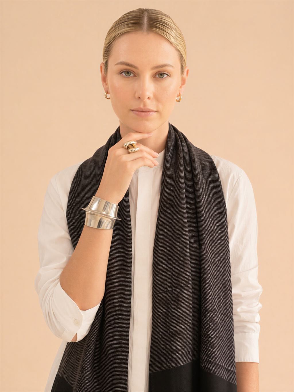 Woman wearing a dark scarf on a beige background