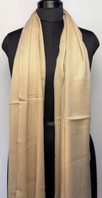 Beige scarf draped over a black mannequin on a white background