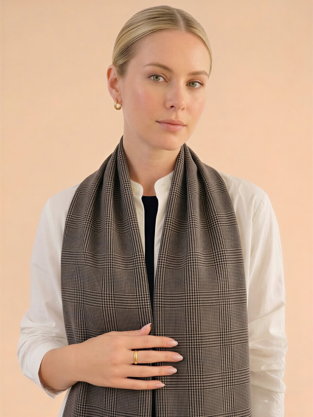 Woman wearing a brown checkered scarf against a beige background