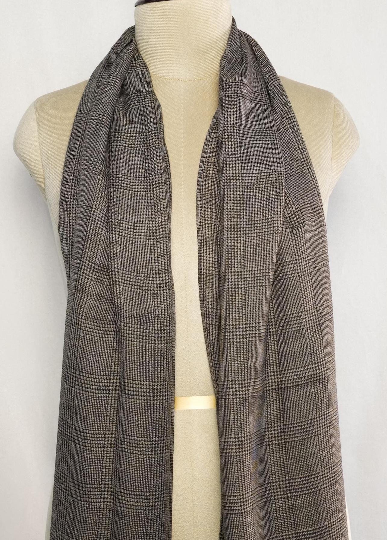 Plaid scarf on a mannequin against a white background