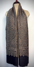 Patterned scarf on a mannequin against a white background