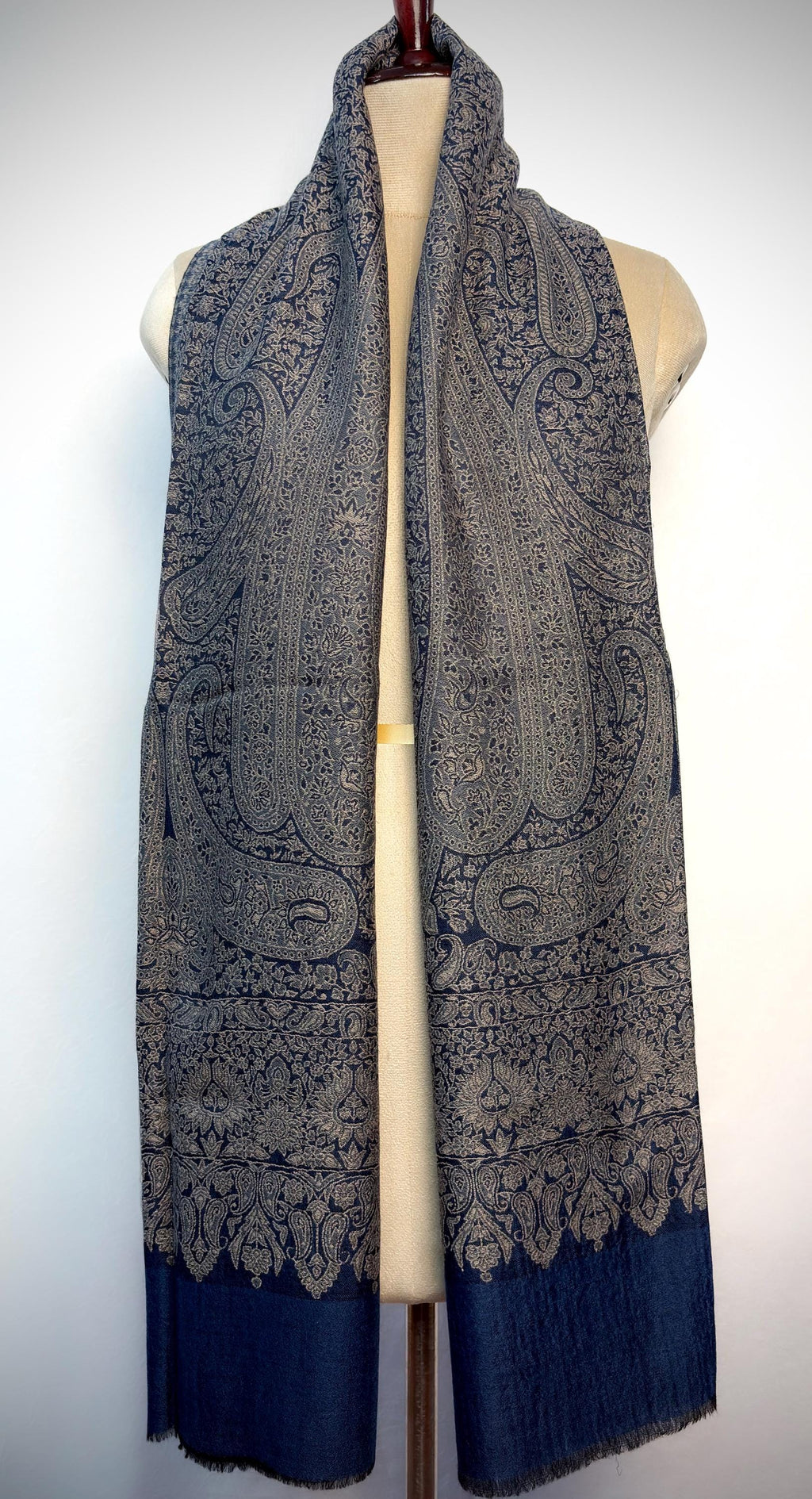 Paisley patterned scarf on a mannequin against a white background