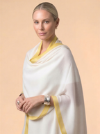 Woman wearing an ivory Kashmiri wool shawl with a mustard yellow border